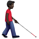 man met taststok: donkere huidskleur, naar rechts gericht